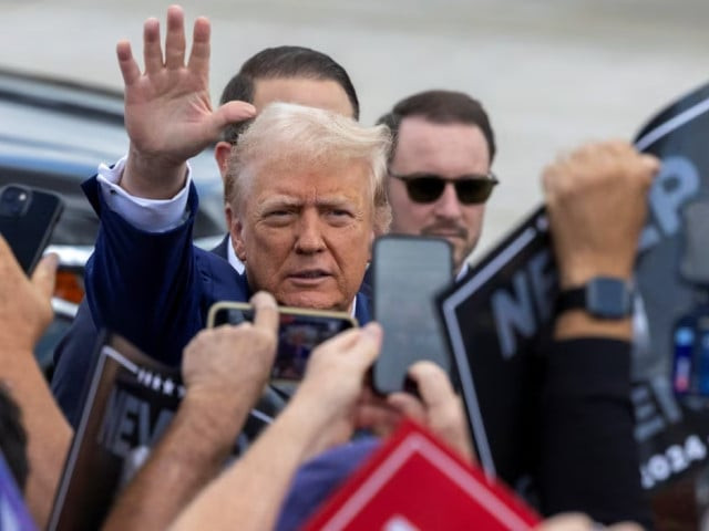 republican presidential candidate and former u s president donald trump waves to supporters at wayne county airport in romulus michigan us august 20 2024 photo reuters